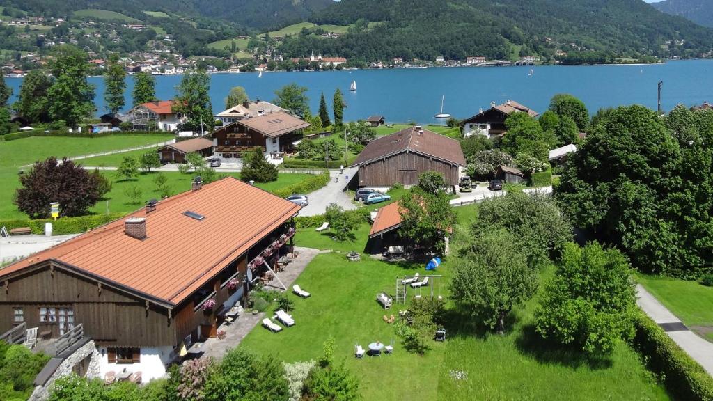 an aerial view of a village with a house and a lake at Ferienwohnungen Budererhof in Bad Wiessee