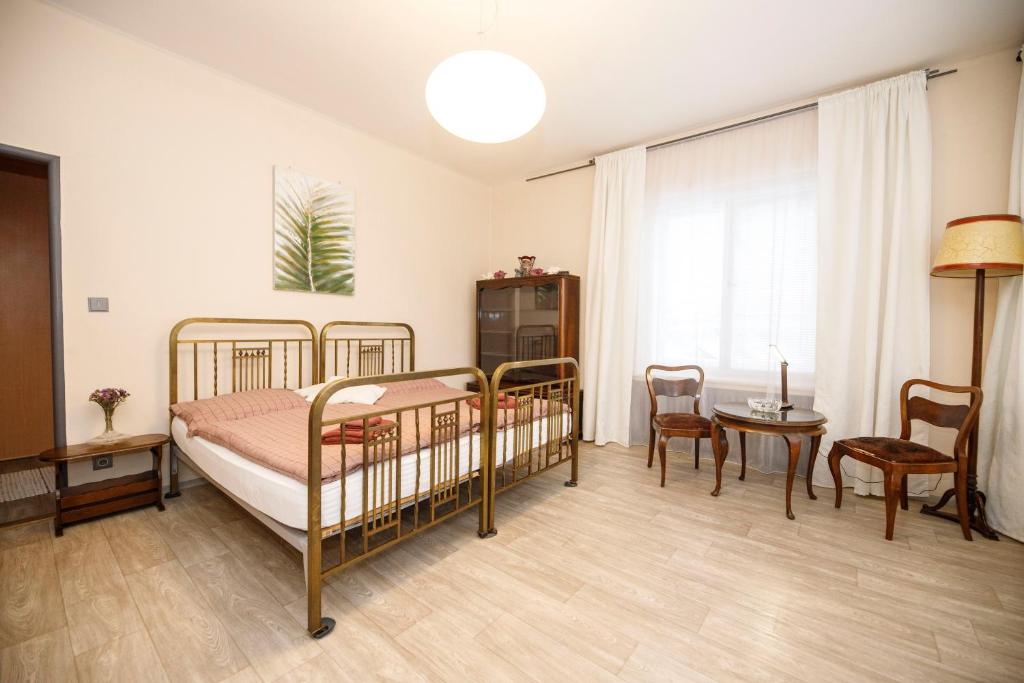 a bedroom with two bunk beds and a table and chairs at Libušina Villa in Kutná Hora