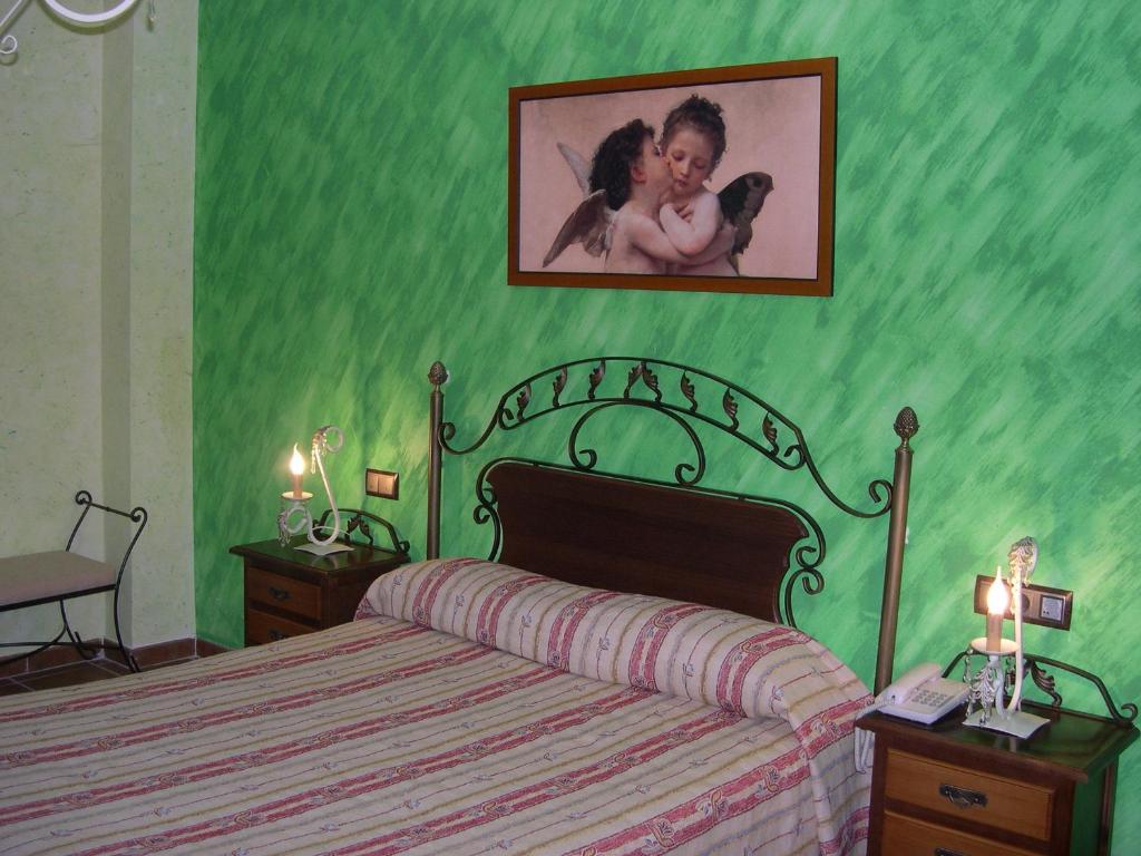 Postel nebo postele na pokoji v ubytování Hotel El Doncel