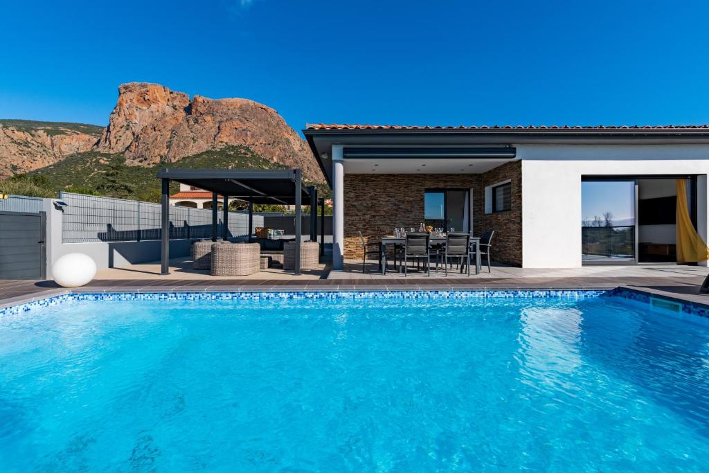 a villa with a swimming pool and a house at Afa proche Ajaccio, magnifique villa avec piscine privée 8 personnes in Afa