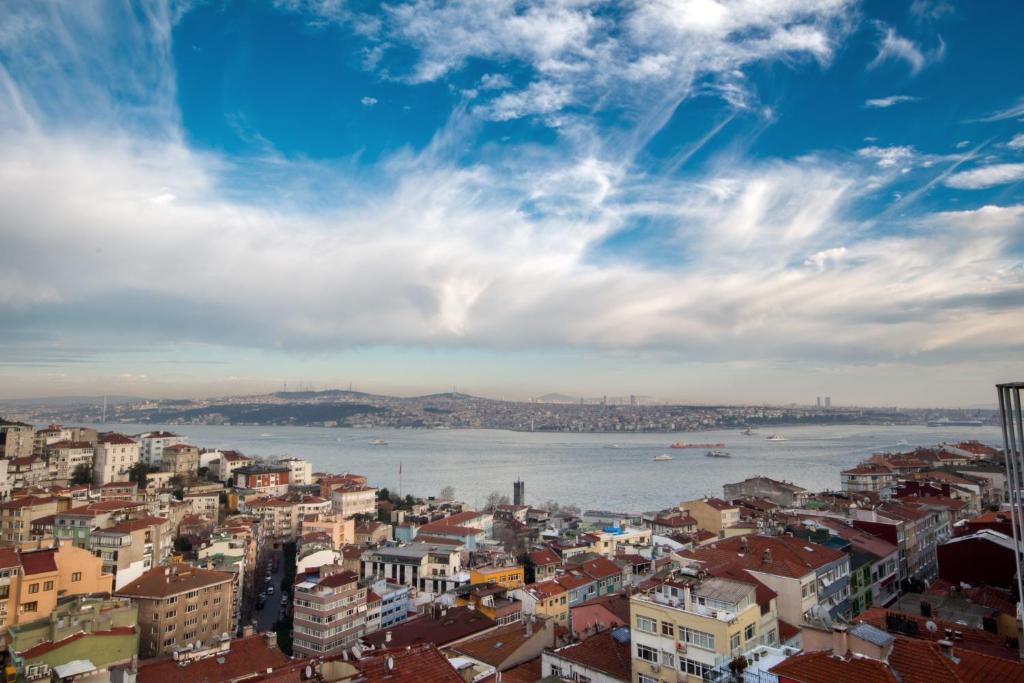 a city view of the water and buildings at Cihangir Hotel Bosphorus in Istanbul