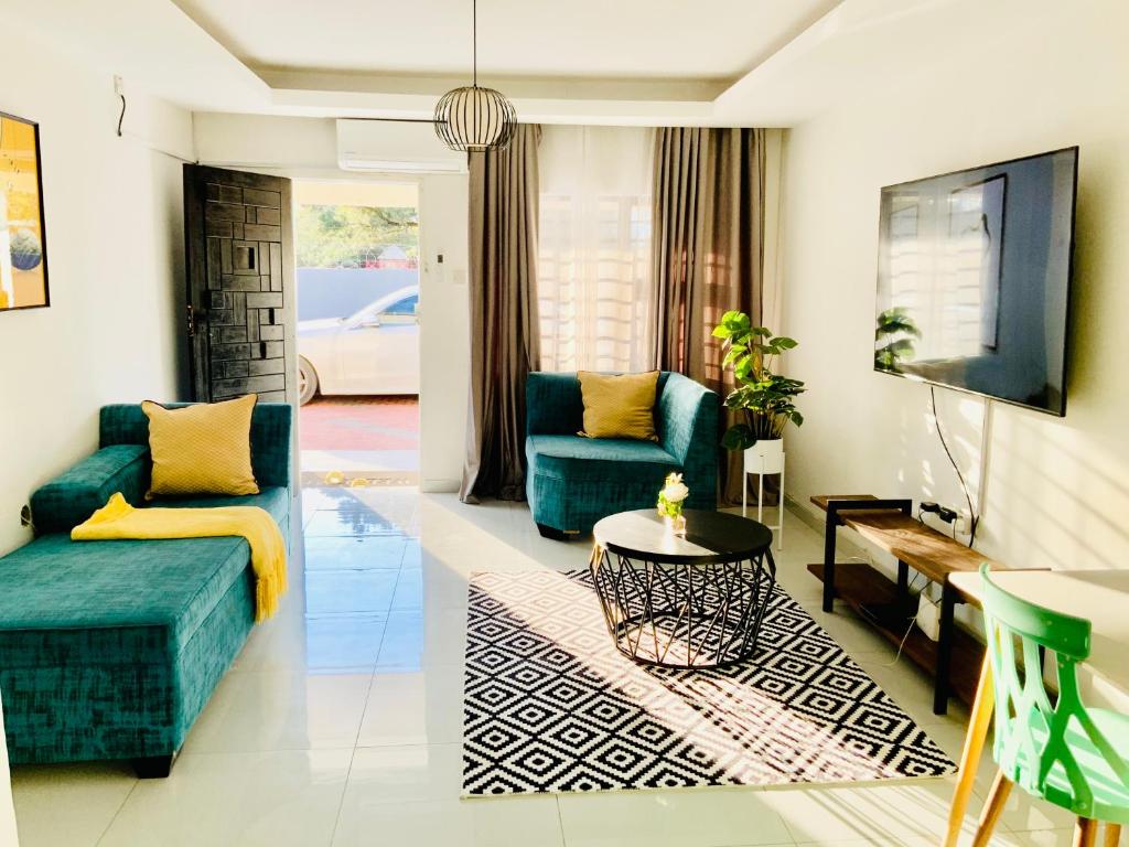 a living room with a couch and a table at Monaco villa Palapye in Palatswe