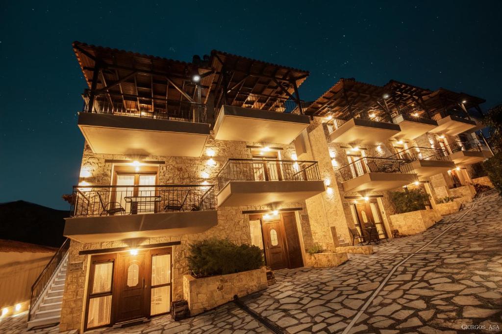 a building with balconies on a street at night at Villas Lirtzis in Taxiarchis