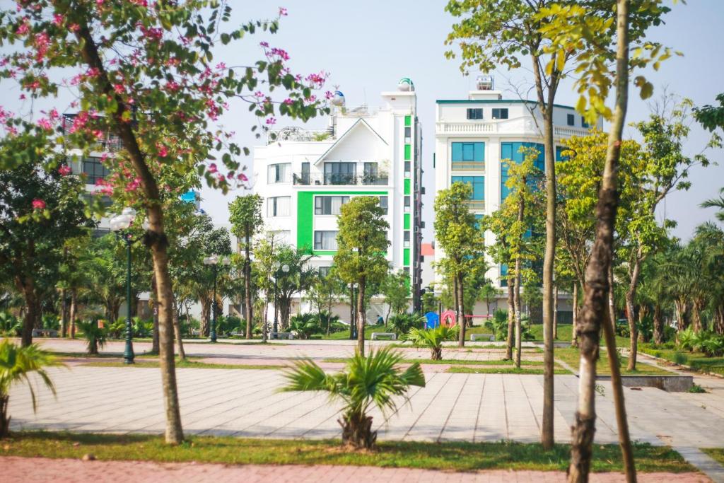 a building in the middle of a park with trees at Green Line Long Bien - Serviced Apartment - Ngoc Thuy - Hanoi in Hanoi