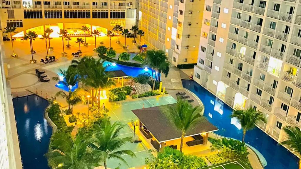 an aerial view of a resort with a pool at Shore 1 Residences MOA Staycation in Manila