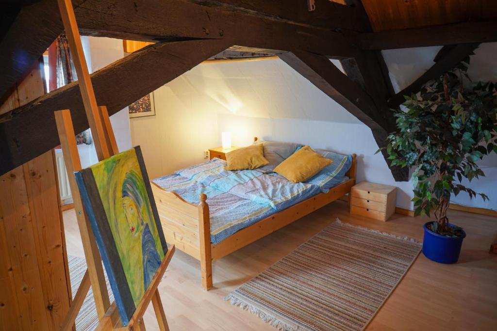 a bedroom with a bed in a attic at My Home is my Castle in Hontheim
