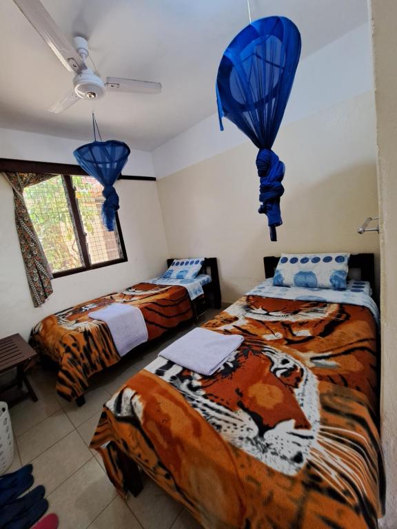 Postel nebo postele na pokoji v ubytování Kwale Golden Guest House