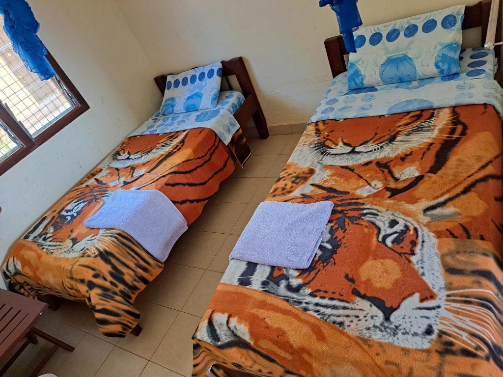 Postel nebo postele na pokoji v ubytování Kwale Golden Guest House