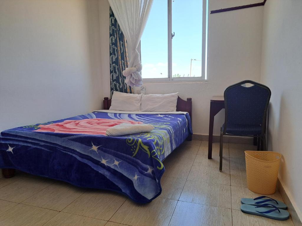 Postel nebo postele na pokoji v ubytování Kwale Golden Guest House