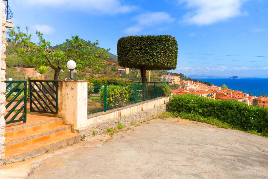 a set of stairs leading to a house with a view of the ocean at Giardino La Panoramica in Rio Marina