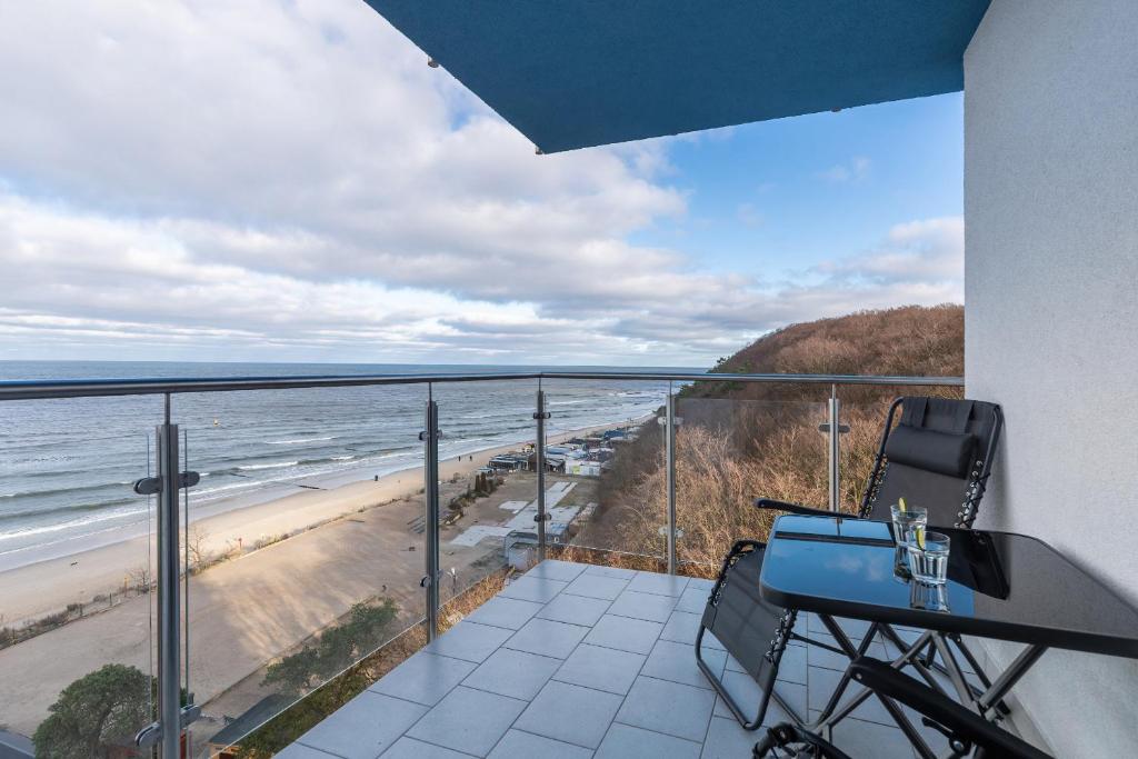 a balcony with a view of the beach at Beachfront Apartment Campingowa by Renters in Międzyzdroje