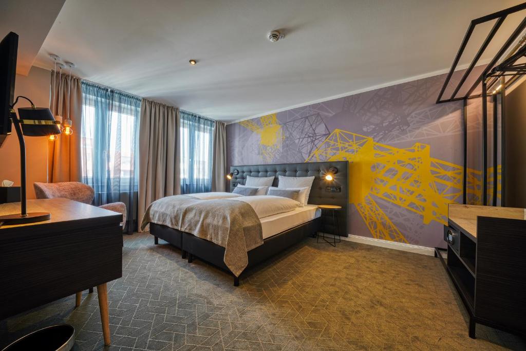 a hotel room with a bed and a mural at NYCE Hotel Dortmund Thier Galerie in Dortmund