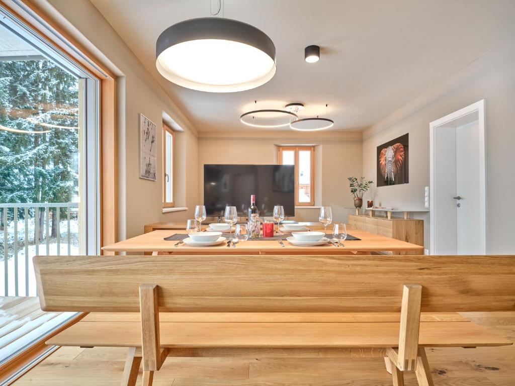 a dining room with a table and a large window at Mountain Lover two in Tauplitz