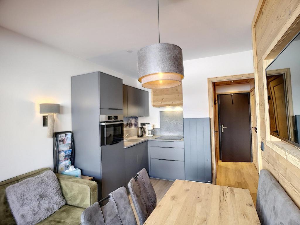 a kitchen and dining room with a table and chairs at Appartement Les Menuires, 2 pièces, 4 personnes - FR-1-178-309 in Les Menuires