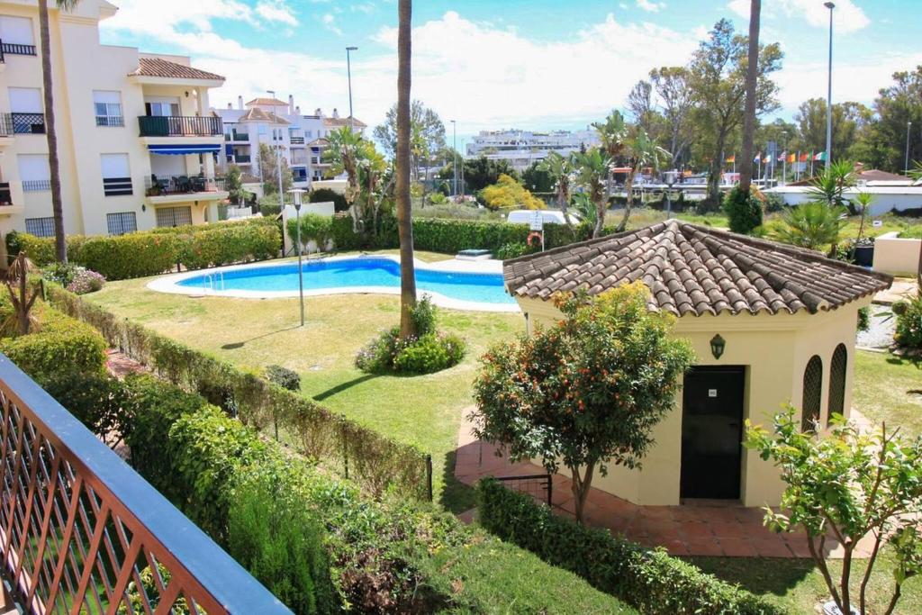 a house with a swimming pool in a yard at Apartment 10 minutes walk from Puerto Banus in Marbella