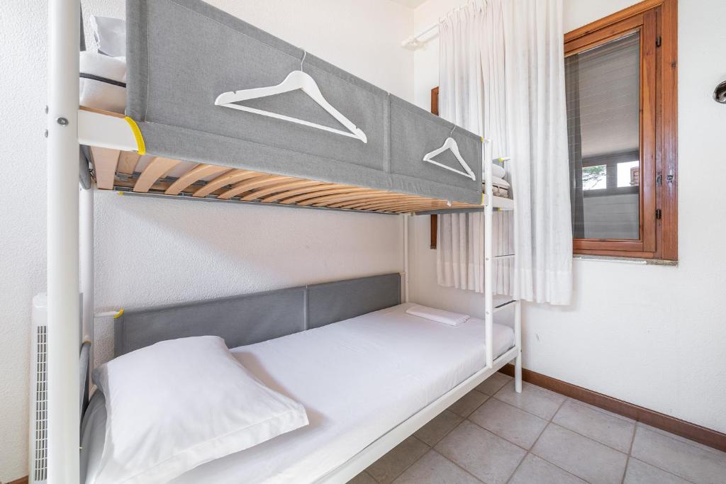 A bed or beds in a room at Domus Luna Apartment with sea view Villasimius