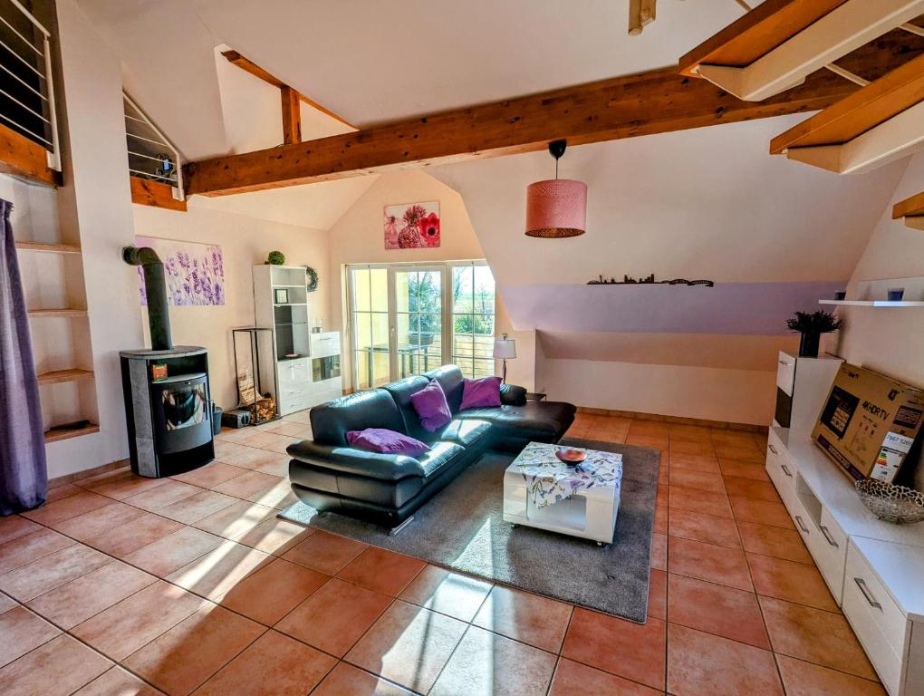 a living room with a couch and a table at Große Schönheit mit Panoramablick in Euskirchen