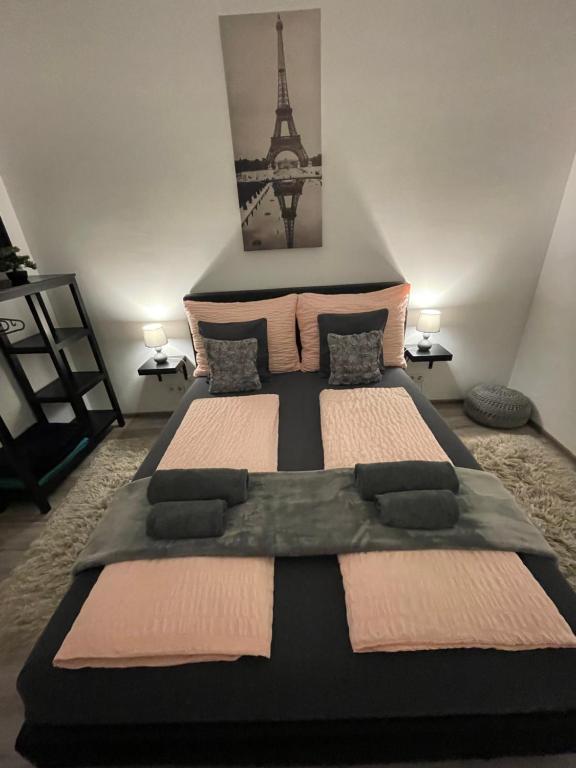 a bedroom with a large bed with the eiffel tower at Palace Residence in Budapest
