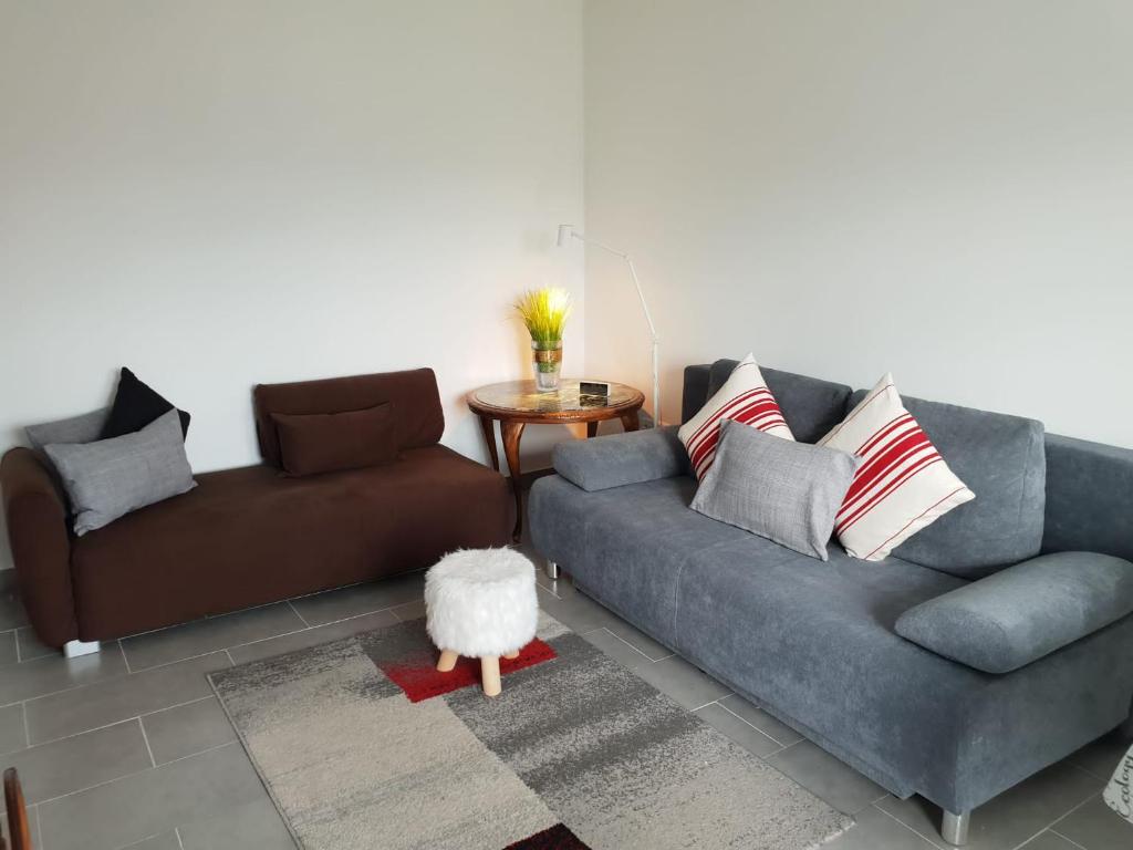 a living room with two couches and a table at Ferienwohnung in Aflenz Kurort in Aflenz Kurort