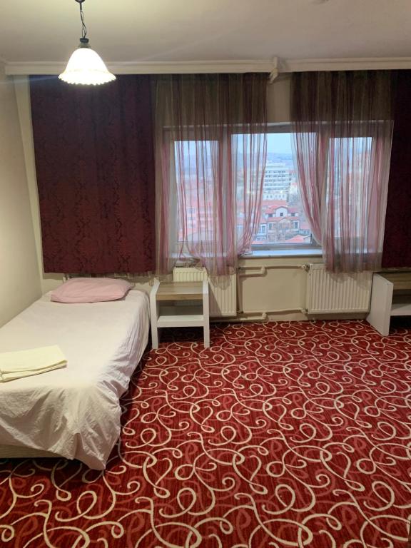 a room with two beds and a large window at Ankara apart Hostel 2 in Altındağ