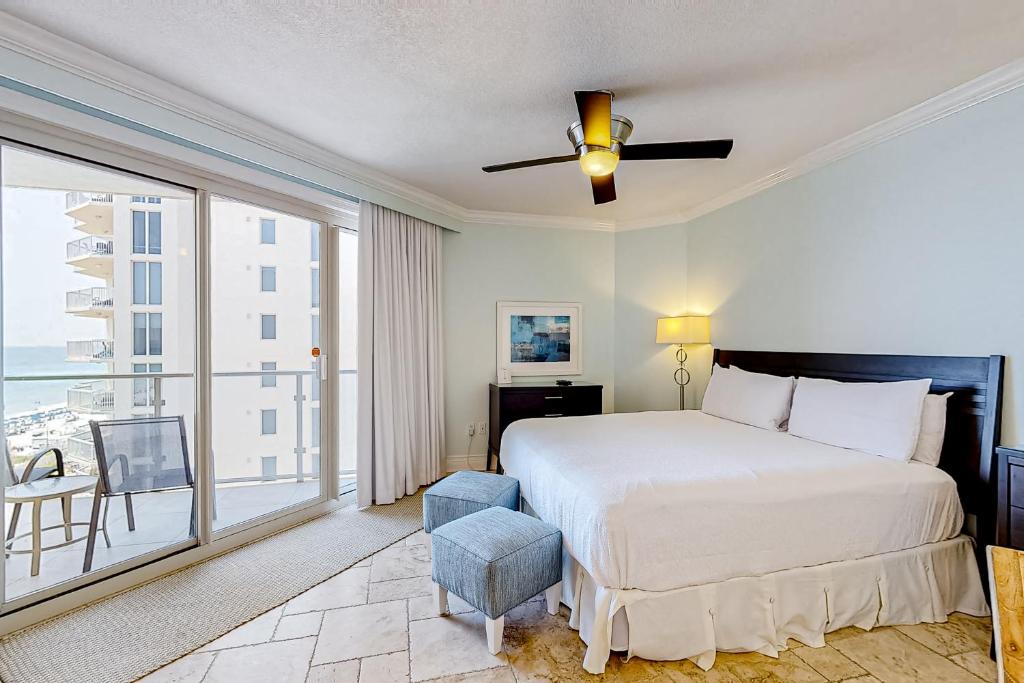 a bedroom with a bed and a large window at Sterling Sands 614 in Destin