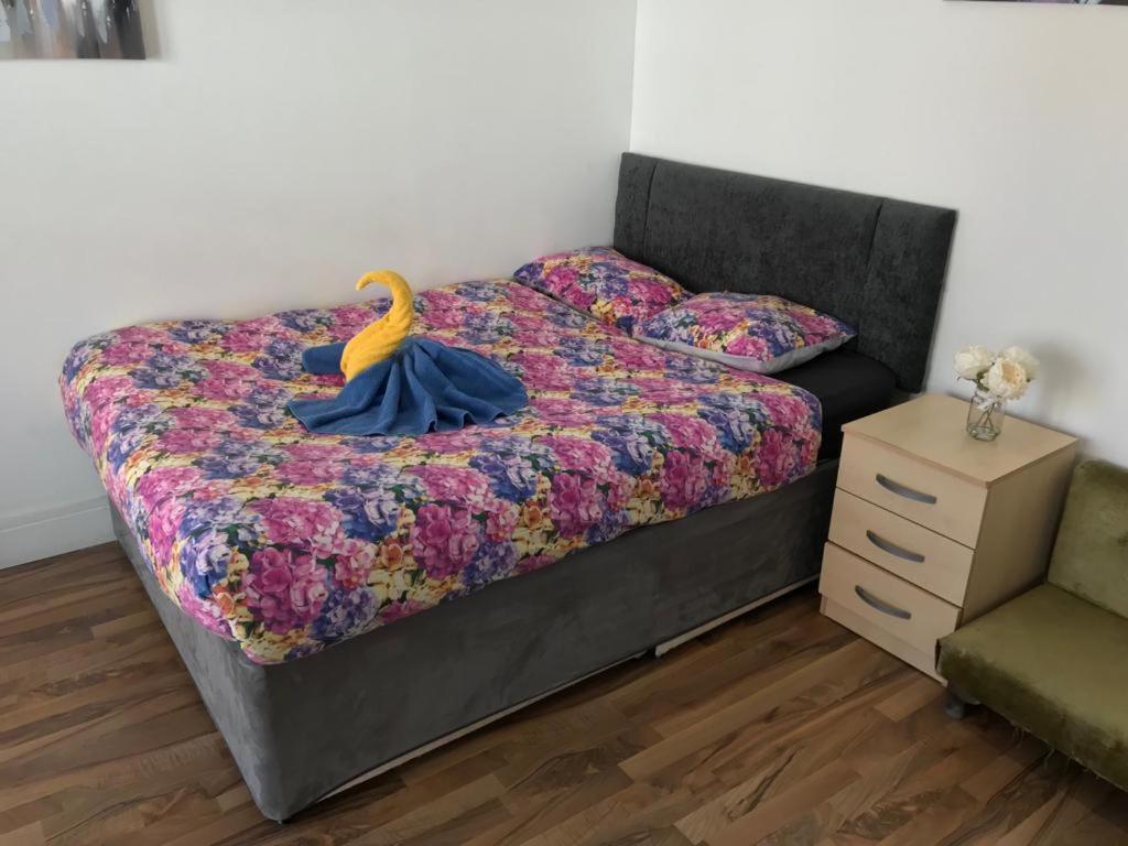a bedroom with a bed with a yellow duck on it at City Sparrow Apartment 6c in London
