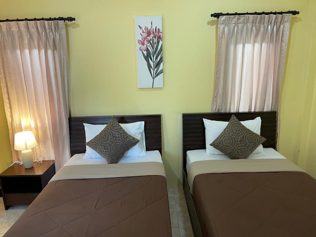 two beds sitting next to each other in a room at Bangtao Hello House in Bang Tao Beach