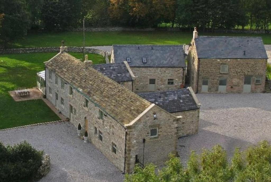 an aerial view of an old stone building at The Old Dairy - Brosterfield Farm in Eyam