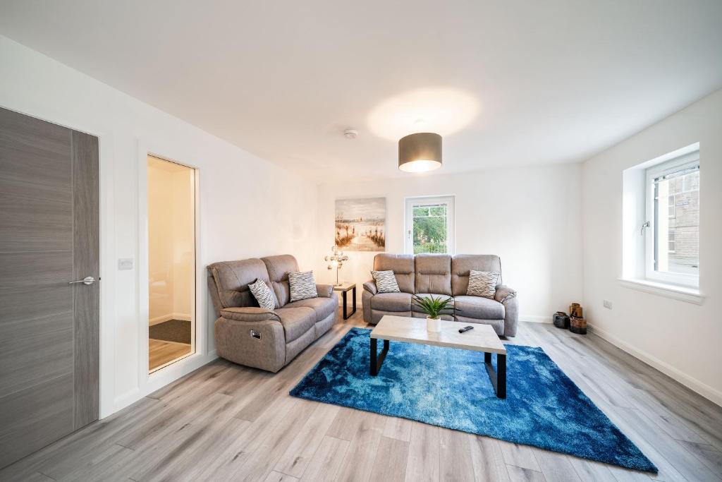 a living room with a couch and a table at South Esk Apartment 8 in Montrose