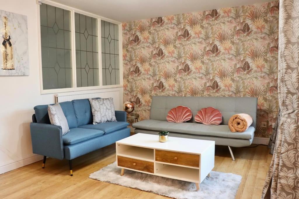 a living room with a couch and a table at Lovely staycation with family FREE Parking & WiFi in Beeston