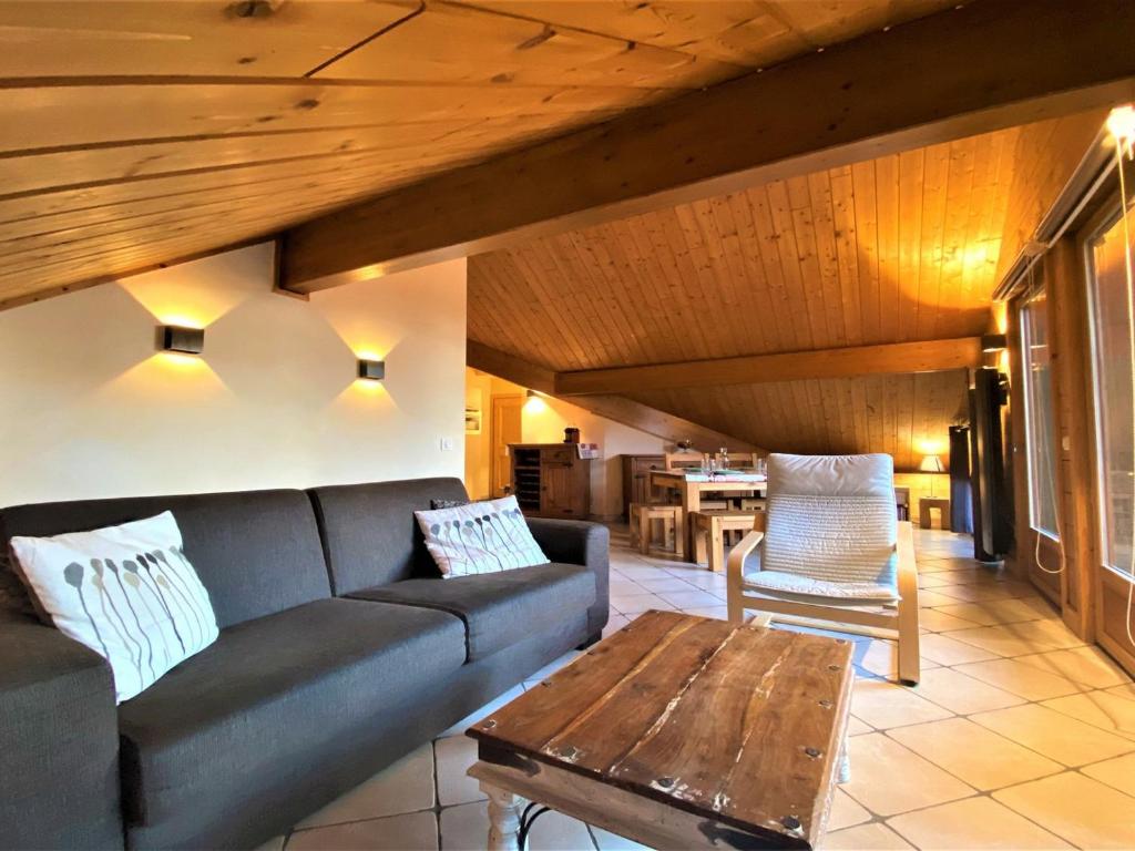 a living room with a couch and a wooden ceiling at Appartement Samoëns, 2 pièces, 5 personnes - FR-1-624-41 in Samoëns