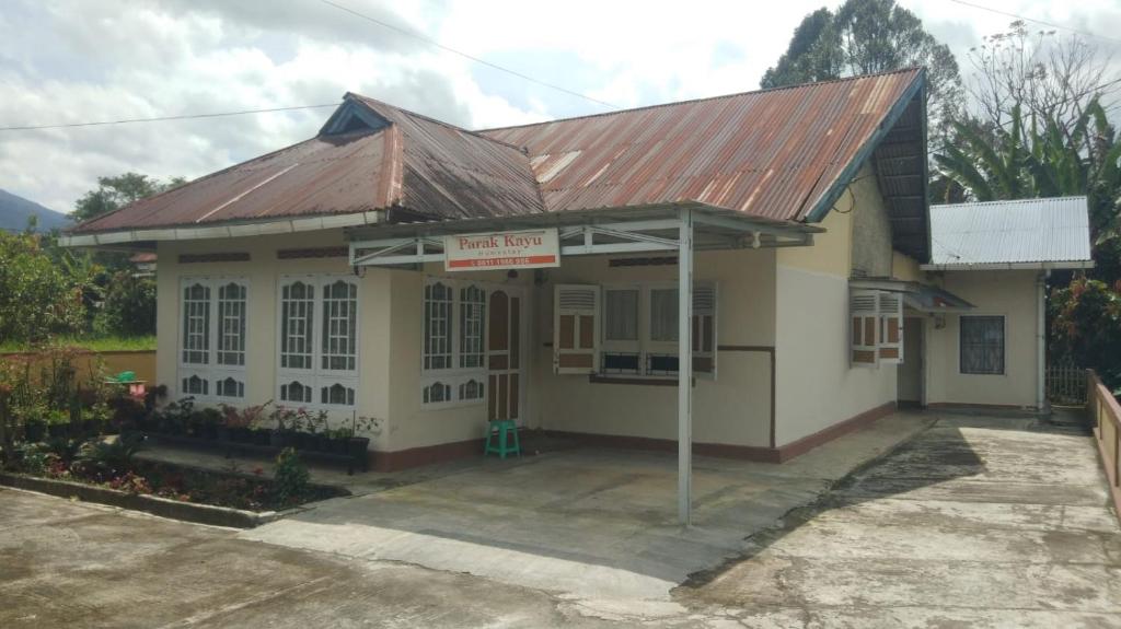 a small building with a metal roof at HOMESTAY PARAK KAYU in Baso