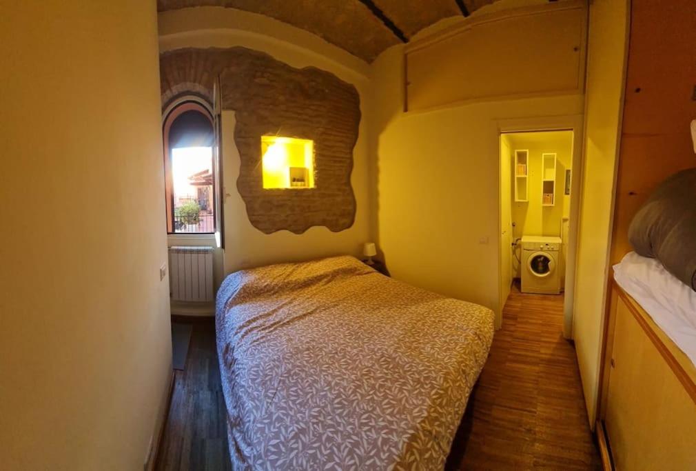 a bedroom with a bed in a room with a window at Julia nel cuore di Trastevere in Rome