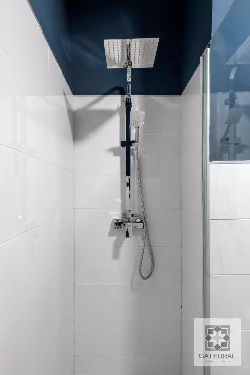 a shower in a bathroom with a blue ceiling at Casa Catedral in Seville