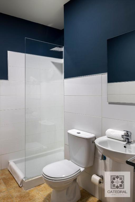 a bathroom with a toilet and a sink and a shower at Casa Catedral in Seville