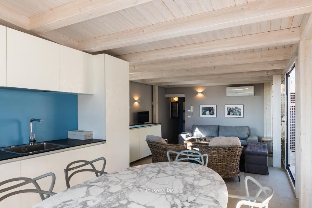 a kitchen and living room with a table and chairs at House&Villas - Terrazza di Erika in Noto