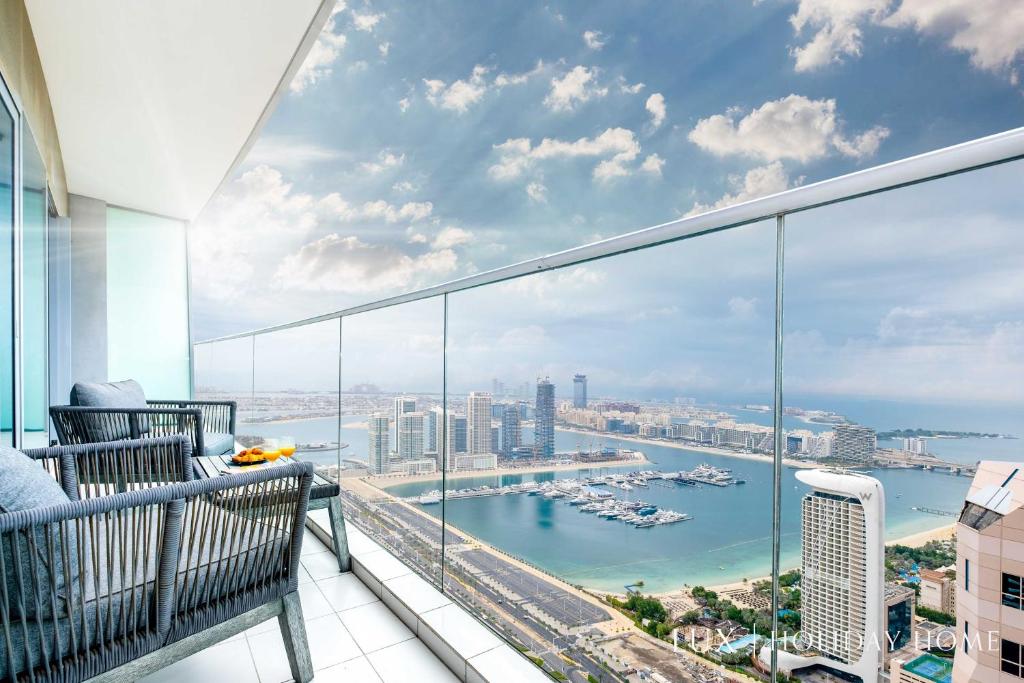 a balcony with a view of a harbor at LUX - Lavish Suite with Full Palm Jumeirah View 2 in Dubai