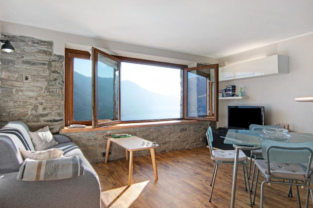 a living room with a couch and a table at Renovated Barn of the year 1500 in Moltrasio