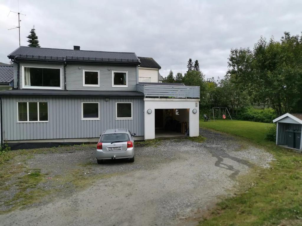 a car parked in front of a house at Big, spacious apartment with free parking in Tromsø