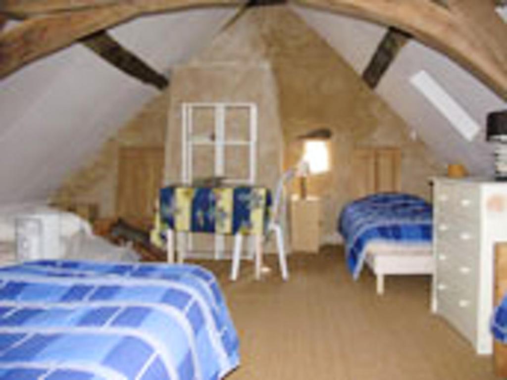 a bedroom with two beds in a attic at Maison spacieuse avec jardin à Morannes sur Sarthe in Saint-Germain