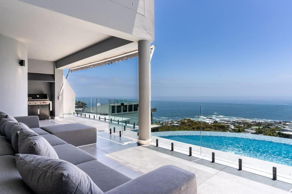 a living room with a couch and a swimming pool at The View CampsBay in Cape Town