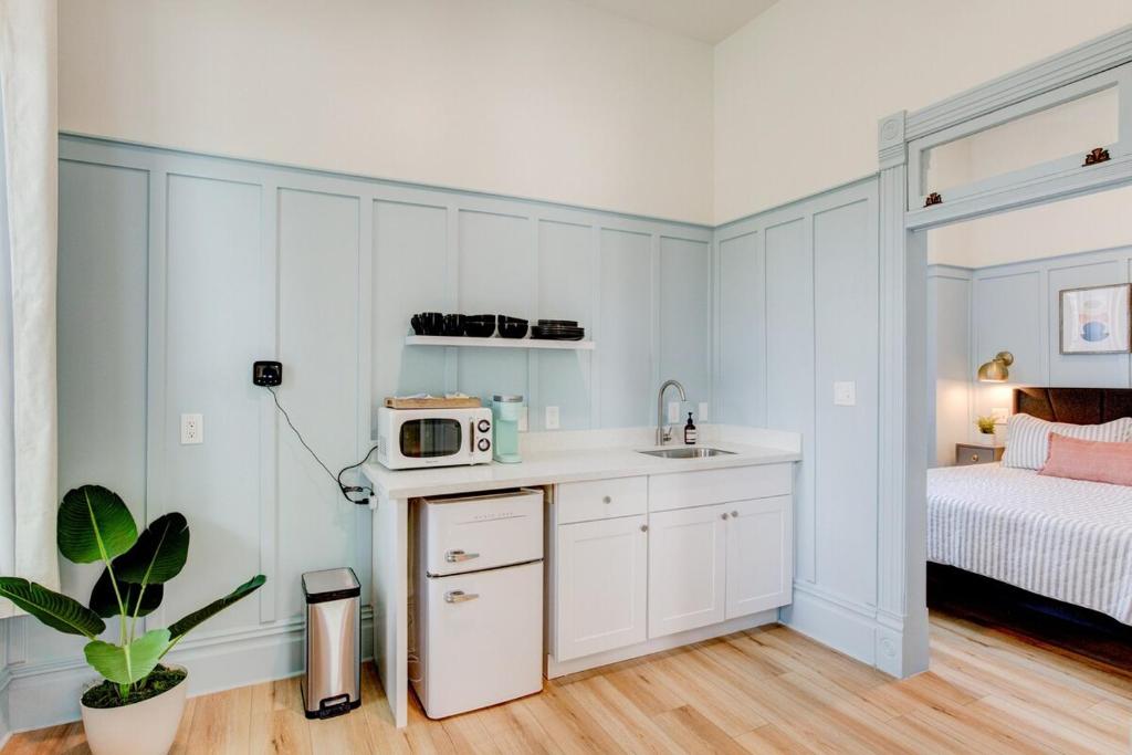 a small kitchen with a sink and a microwave at Suite 3 Historic Art City Inn in Springville