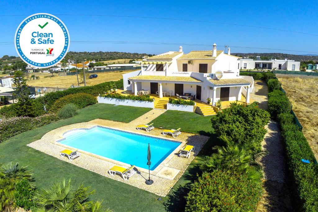 an aerial view of a house with a swimming pool at G - Vila Céu Guesthouse in Odiáxere