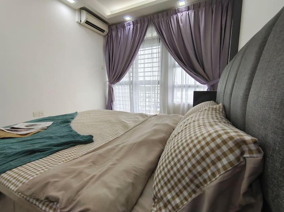 a bedroom with a bed with purple curtains and a window at 0505 The Garden Residences wifiNetflix By STAY in Johor Bahru