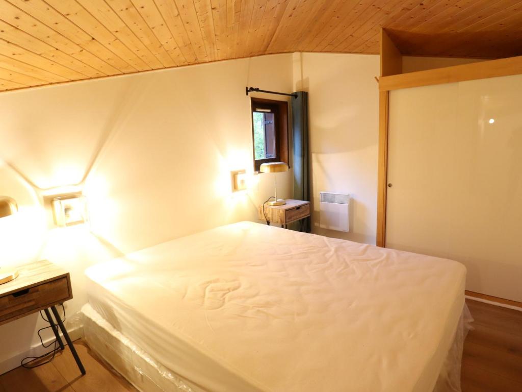 a bedroom with a white bed and a wooden ceiling at Appartement Les Gets, 3 pièces, 4 personnes - FR-1-623-292 in Les Gets