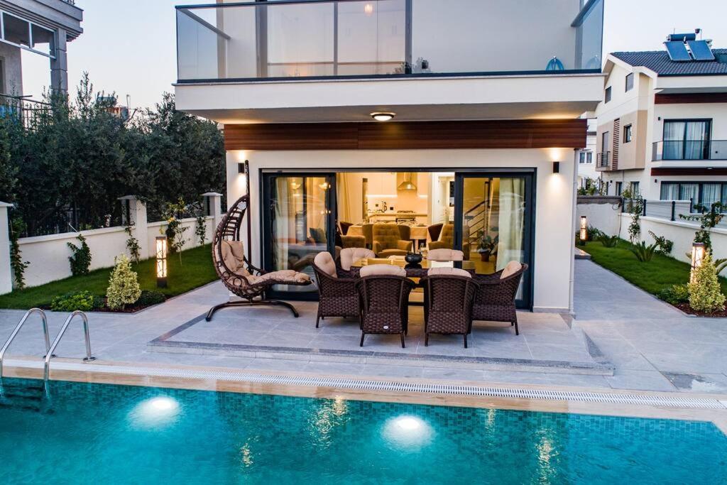 a house with a swimming pool next to a house at merkezde 8 kişilik özel havuzlu villa in Fethiye
