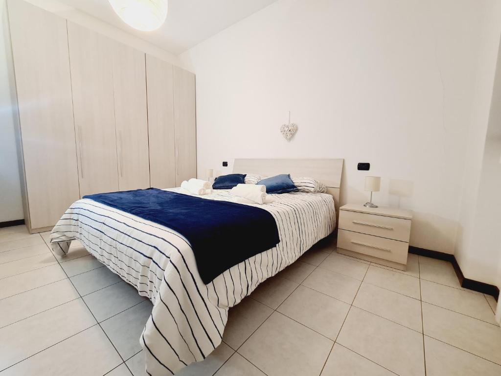 a bedroom with a bed with a blue and white blanket at San Siro House in Milan