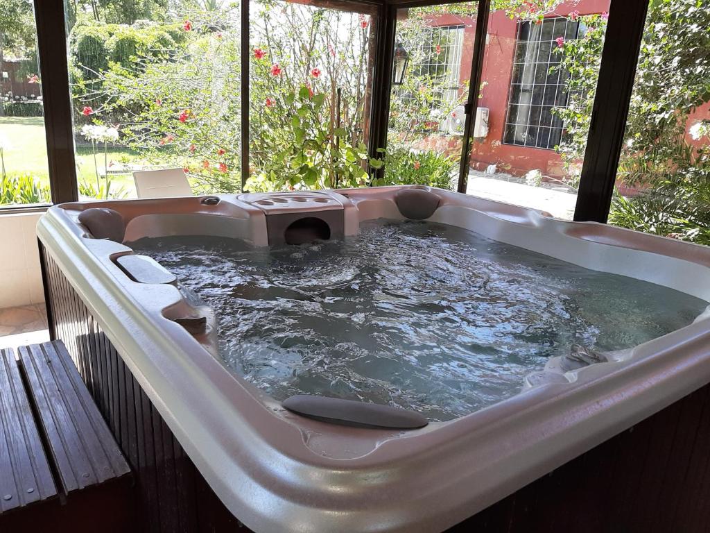 a jacuzzi tub with a dog sitting in it at Estancia Renacimiento in Atlántida