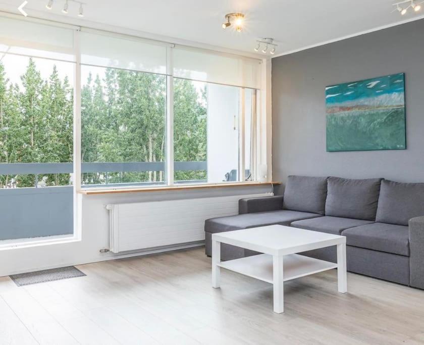 a living room with a couch and a table at Cozy apartment in Akureyri in Akureyri