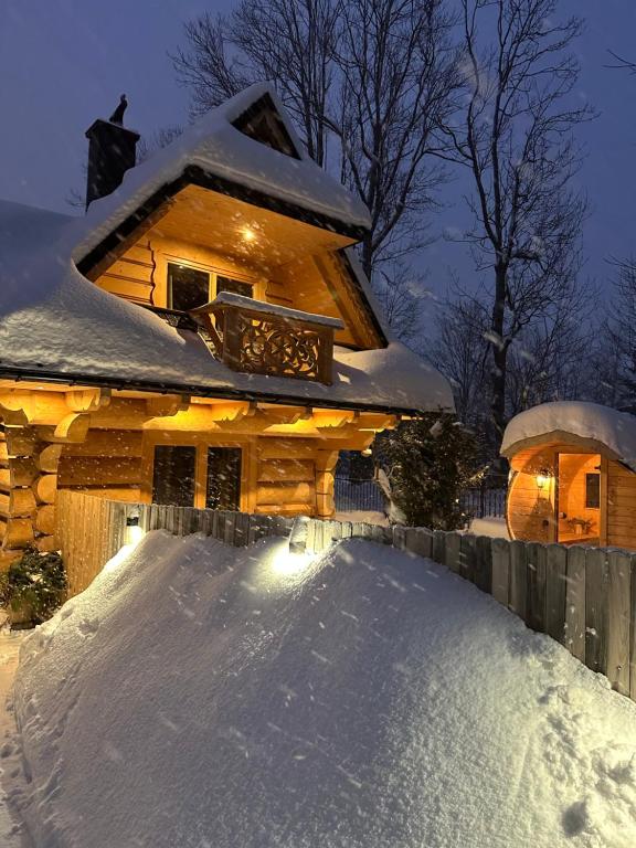 a pile of snow in front of a house at Tatra Chalet Krupówki 77A in Zakopane